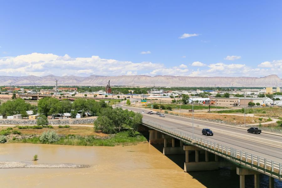 Photograph of Highway bridge over Colorado River with Bookcliffs in  background