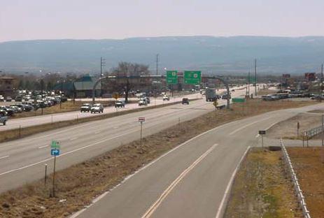 Arial Photograph of the I 70 Business Loop with traffic traveling in both directions and mountain range in the background