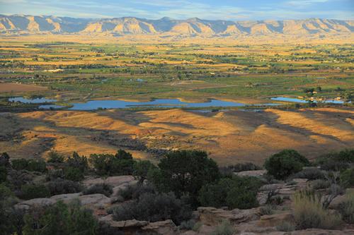 Aerial photograph of the Grand Valley with mountain range in the background