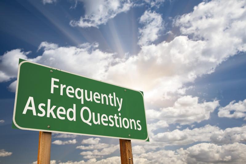 Photograph of Frequently Asked Questions Green Road Sign with Dramatic Clouds and Sky.