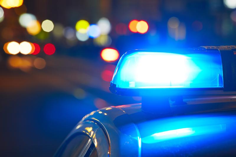 Photograph of Police Car with lights flashing.