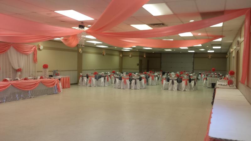 Photograph of the community building interior decorated with tables and chairs