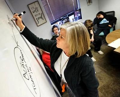 Jacque Berry, right, Director of Juvenile Diversion for Colorado’s 21st Judicial District, meets with Blair Parmenter, his family and his tutor with The Lighthouse Program Feb. 28 at her office in Grand Junction. (Barton Glasser, Special to The Colorado Trust)