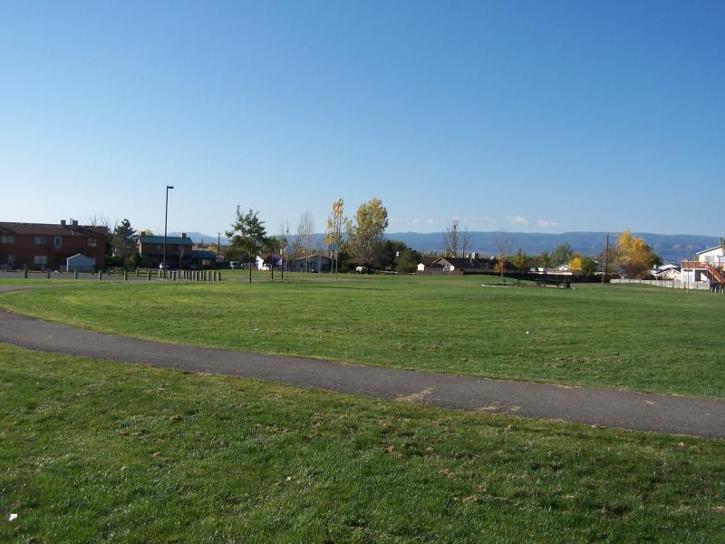 paved path through the grass