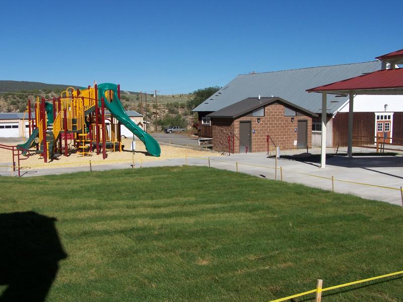 Photograph of the community center, playground, and the lawn