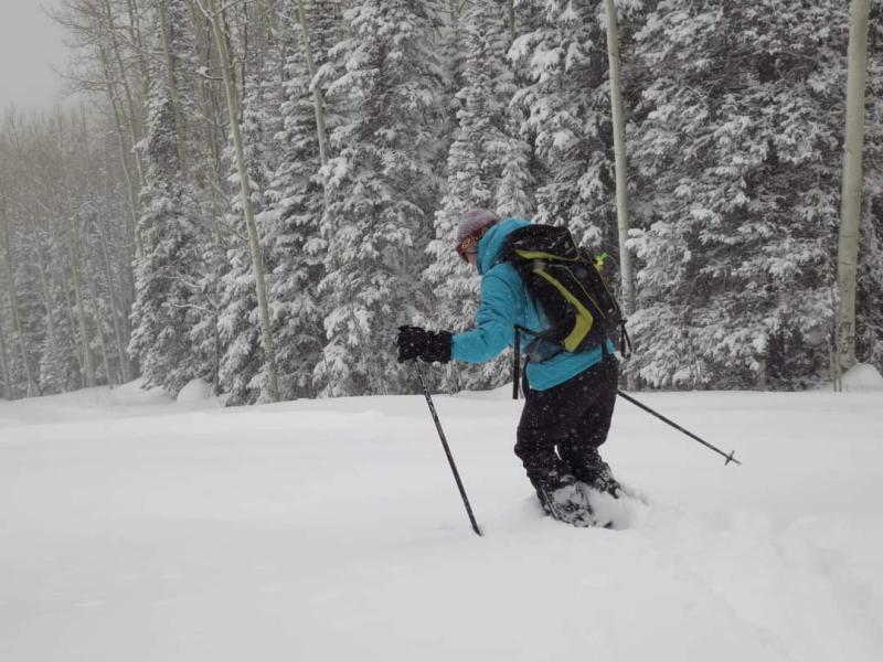 Backcountry skier in powder with black and white background