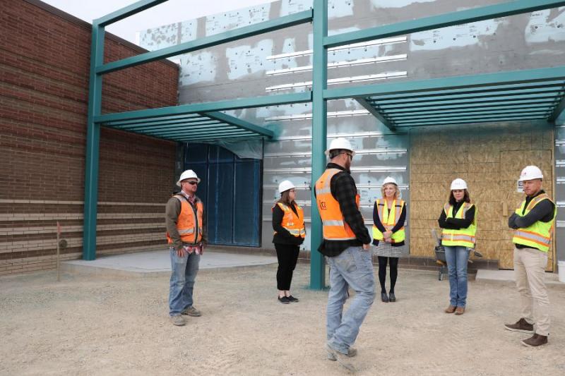 County officials stand outside Clifton Community Campus unfinished. 