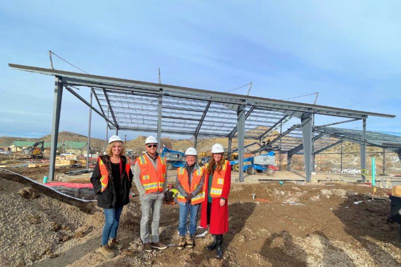 Board of County Commissioners and Town of De Beque Manager in front of unfinished De Beque Community Center. 