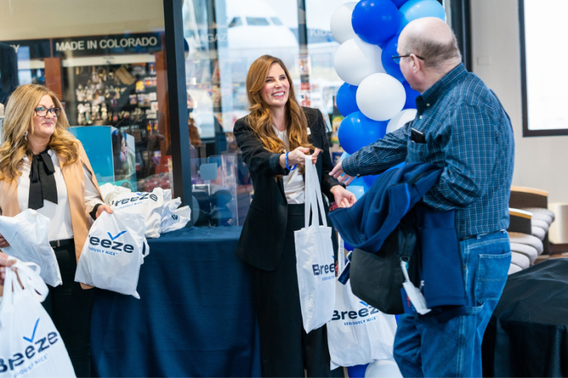 Mesa County Commissioner Bobbie Daniel helps give out Breeze Airways giftbags.