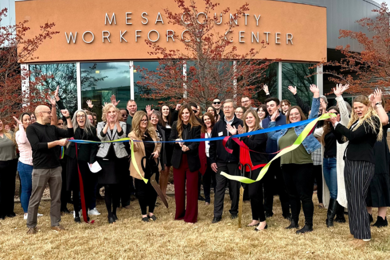 People gather outside the Mesa County Workforce Center for a ribbon cutting event.