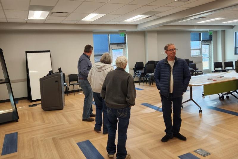 People walking around room during open house. 