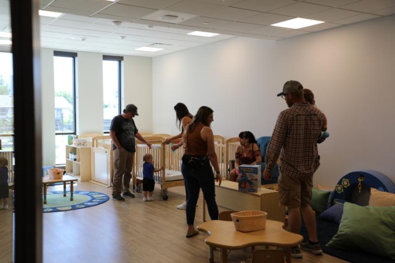 People walking around in daycare facility. 