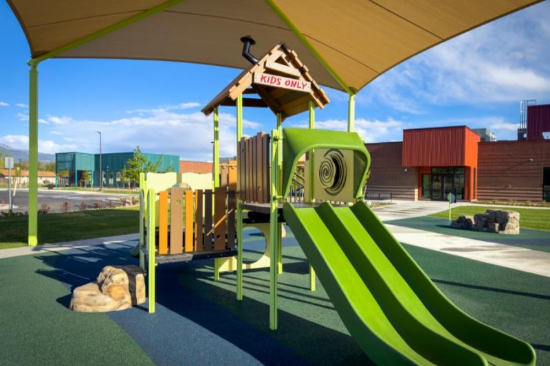 Green playground with sign reading, "kids only."