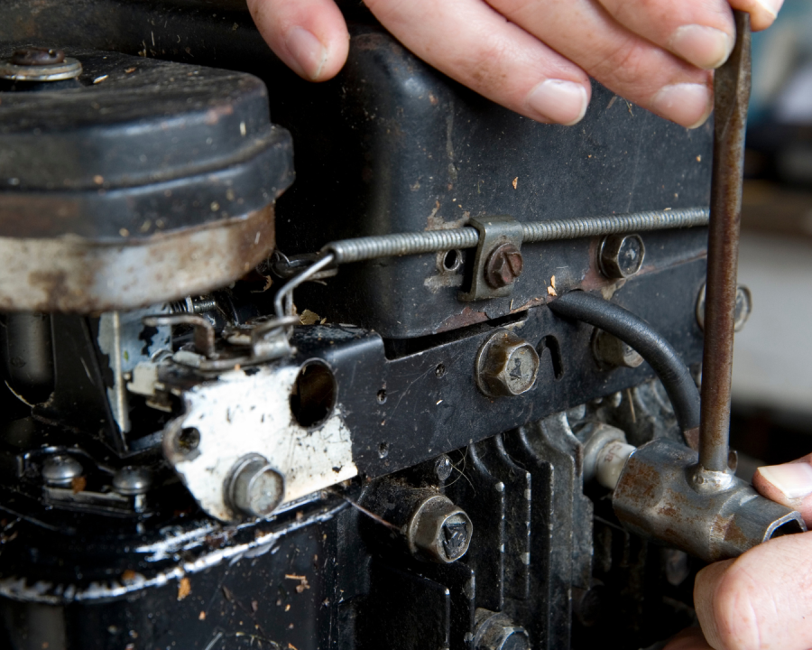 Hands repair a piece of machinery