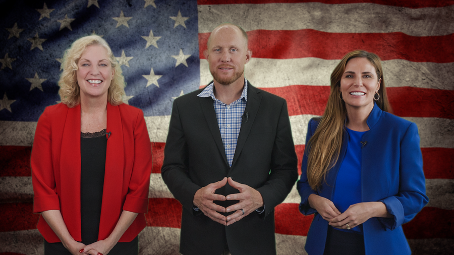 The Board of Mesa County Commissioners standing in front of American flag. 