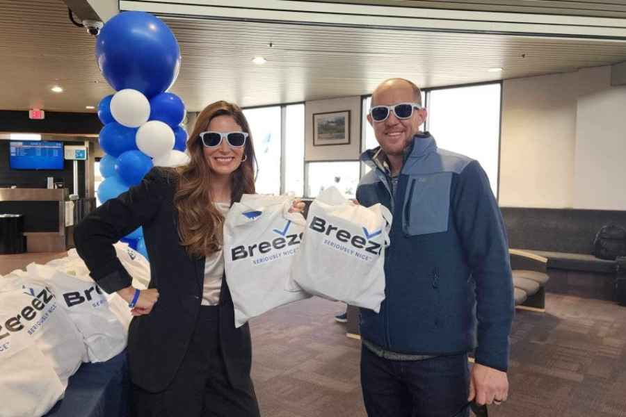 Mesa County Commissioners Bobbie Daniel and Cody Davis smile while holding Breeze Airway bags.