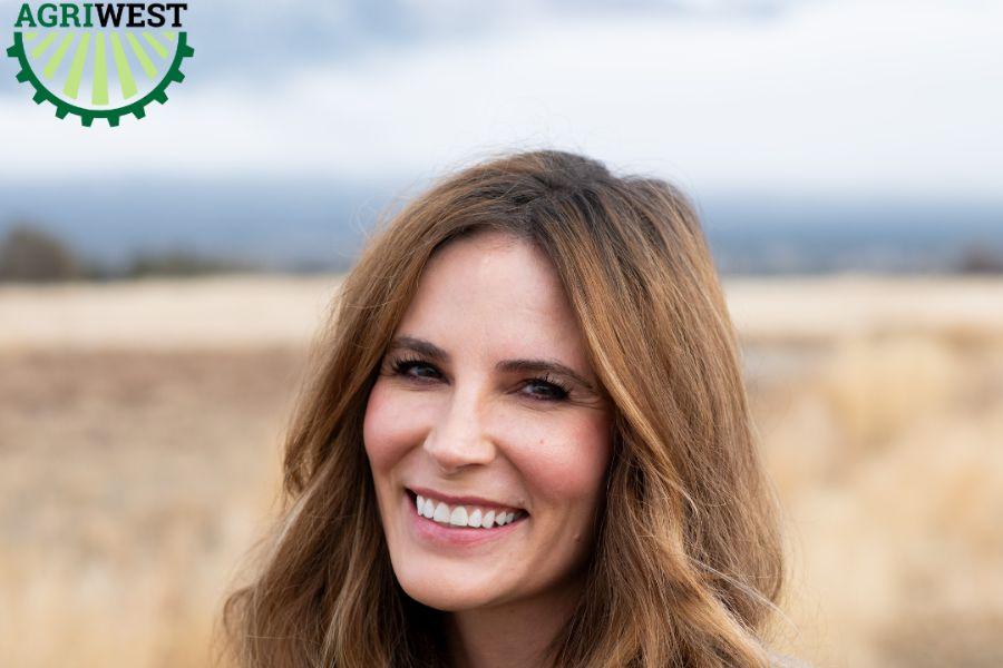 Woman (Commissioner Bobbie Daniel) smiles in headshot with blurred open space background. 