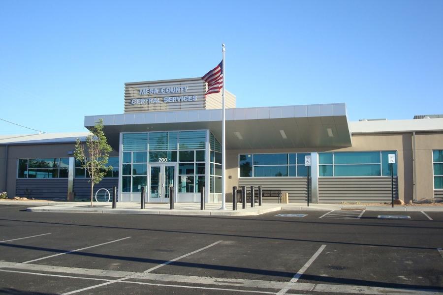 Mesa County Central Services building with American flag in front. 