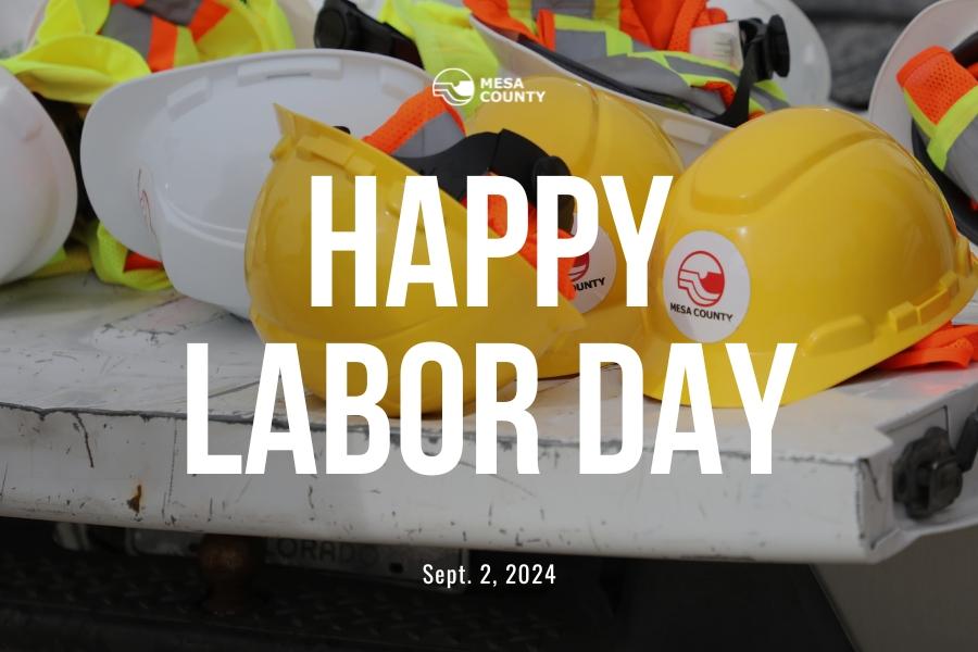 Yellow hard hats with Mesa County logo stickers and white text reading, "HAPPY LABOR DAY Sept. 2, 2024."