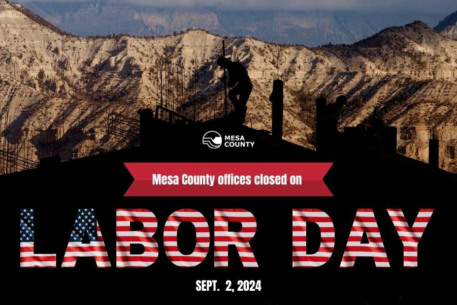 Hills in Colorado covered by black shadow of construction workers working on city and red white and blue text reading, "Mesa County offices closed on LABOR DAY SEPT. 2, 2024."