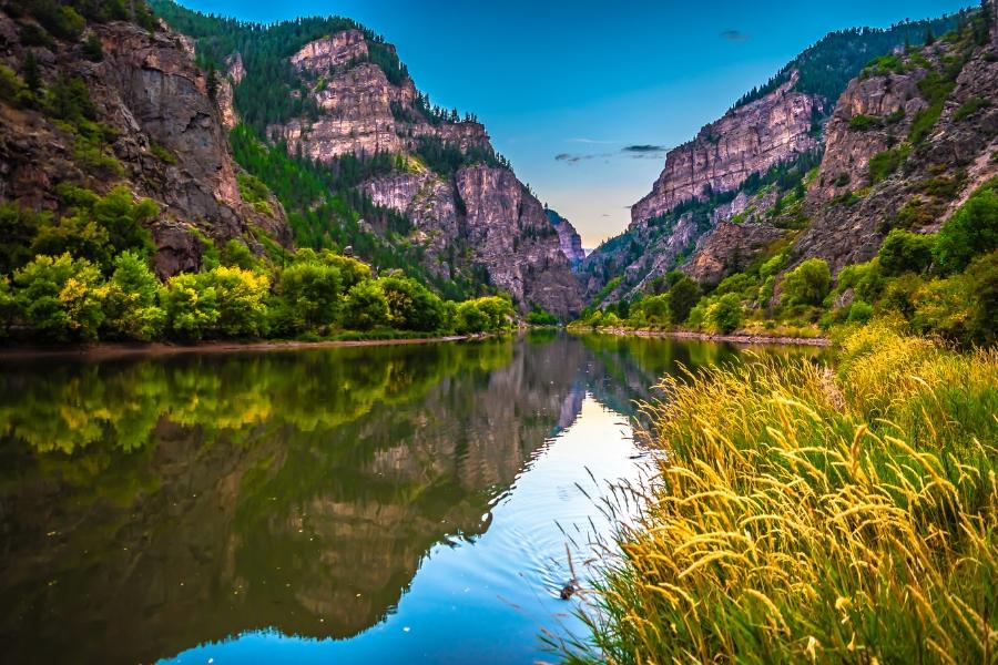 River surrounded by canyons and greenery.