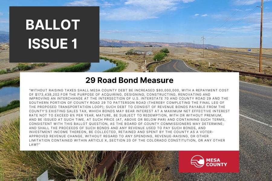 Road near water with text reading, "Ballot Issue 1 29 Road Bond Measure" and the Mesa County logo at the bottom. 